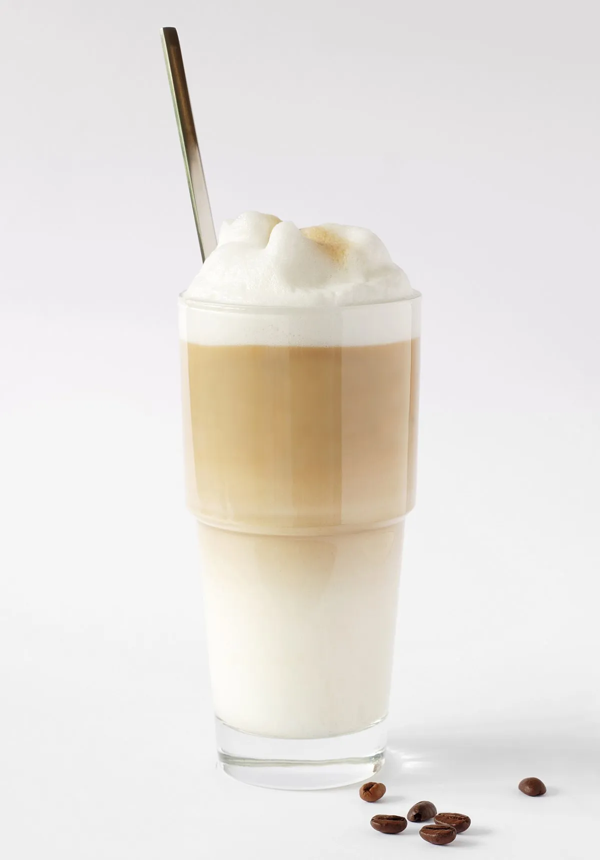 A transparent glass filled with a latte macchiato.